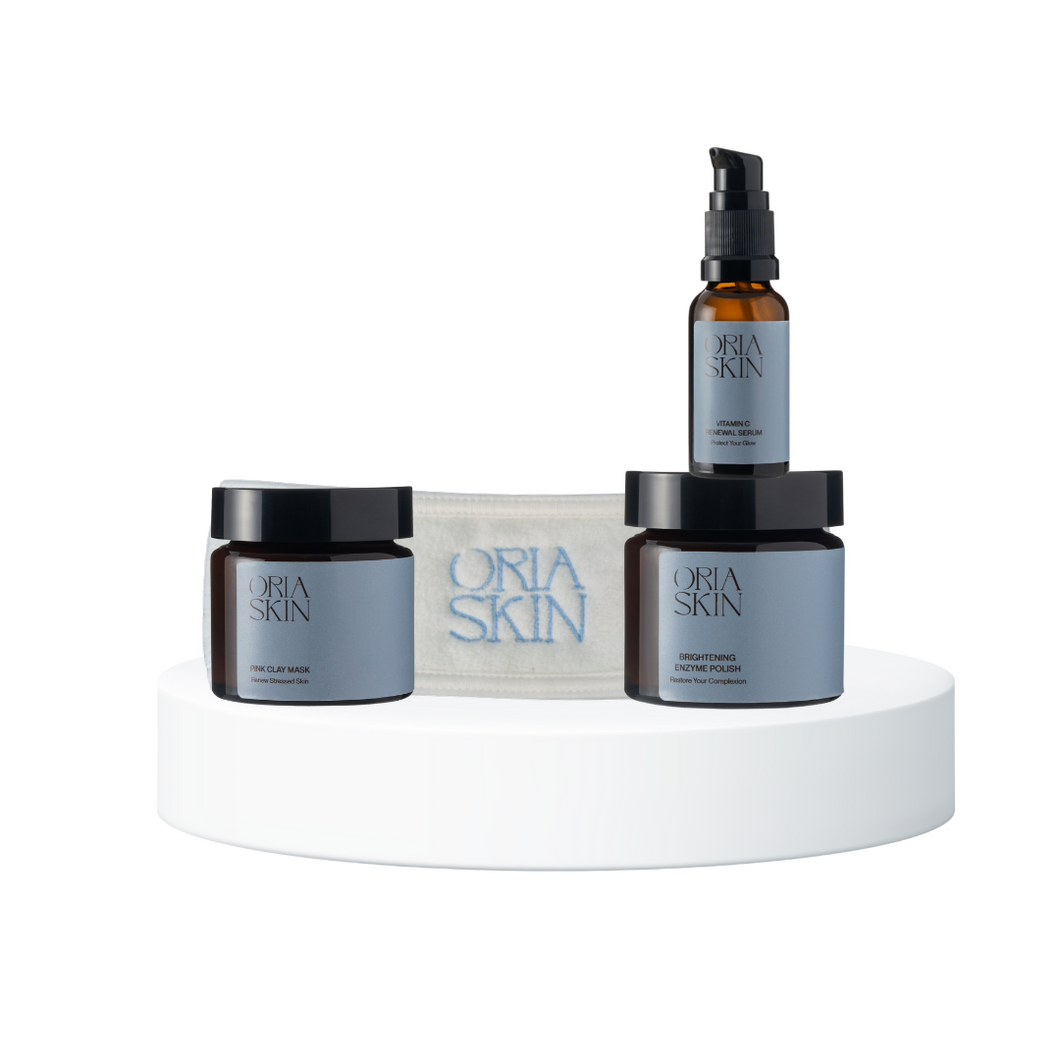 Oria Skin skincare products on a white platform with a white background