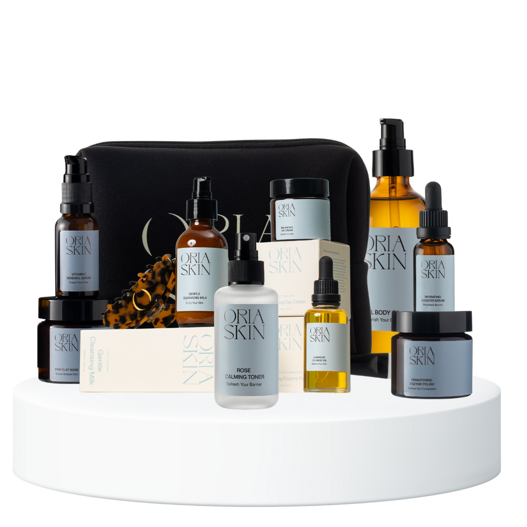 Oria Skin skincare products on a white platform with a black pouch.